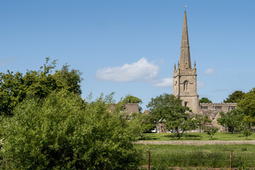 View across the River Thames to St Lawrence Church, Lechlade, Gloucestershire. UK.