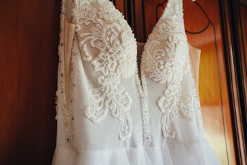 A wedding dress awaiting the bride. Close-up.
