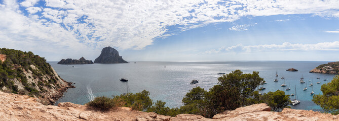 Super panoramic view of bay, yellow rocks surrounding the bay Cola d'Hort, green pine trees and...