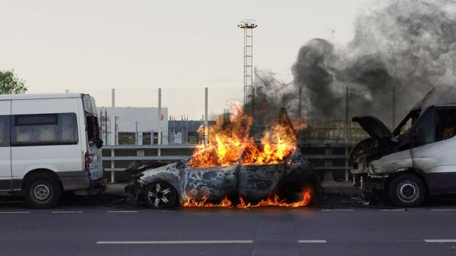 Car on fire. Burning Car. Automobile on fire. Transport explosion. Accident on roadside. Car engulfed in flames with lot of smoke. Burning car body, burning iron, broken car on fire. 
