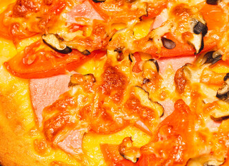 Pizza with tomatoes and sausage as a background.