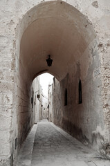 Tunnel with a lantern in a narrow street in the old historical town of Mdina in Malta
