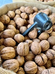 nut cracker on shelled walnuts in burlap bag