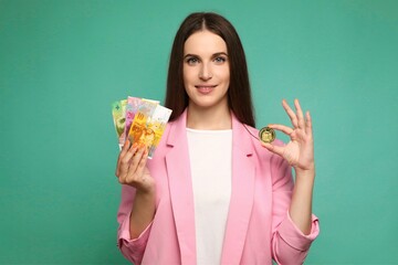 Portrait of young woman holding dogecoin and swedish krona banknotes