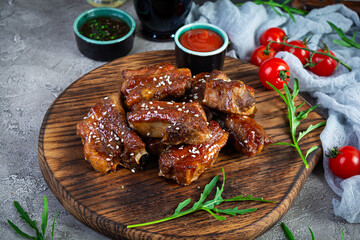 Grilled sliced ribs in sweet and sour sauce. Ribs marinated in honey sauce with herbs
