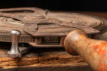 Vintage antique tape measure ruler rusty with a wood handle, coiled tape measurer