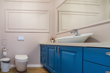 Fototapeta na wymiar Interior of stylish bathroom room in modern house with white toilet bowl and wash basin.