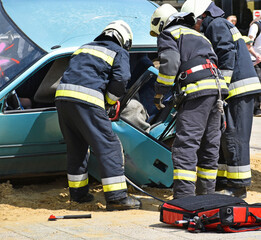 Fototapeta premium Firefighters at work outdoor in the street