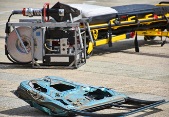 Door of a vehecle and a stretcher in the background