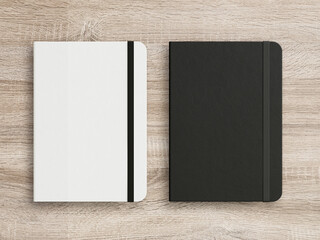 Black and White moleskine isolated on the wooden background.