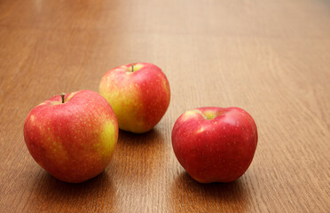 three red apples on the table