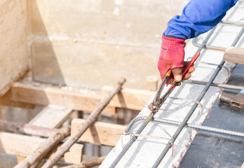 Woker holding pliers Bundle wire steel rebar.