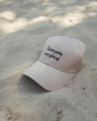 message on the sand, message on the cap, cap on the sand, motivation on the cap, motivation clothing, keep on going, never give up, clothes with text, sand on the beach, modern peak cap, 