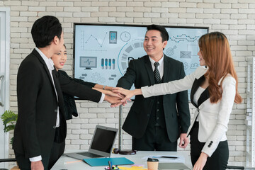 Asian business team show unity with their hands in the office meeting room for assigned tasks that must be accomplished together