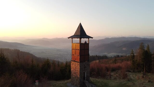Sunrise over the Slovak countryside with a view near the town of Zborov nad Bystrica. Stone tower on the valley of Oravsk&aacute; magura. Morning orange soft light. Drone shot