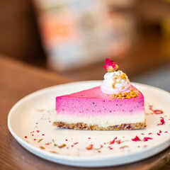 Trozo de pastel vegano de Pitahaya decorado con flores. Delicioso desayuno/brunch. Tarta de fruta.