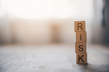 wooden block with the word "RISK". Concept risk management..