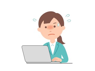 パソコンで、激務をこなすビジネスウーマン