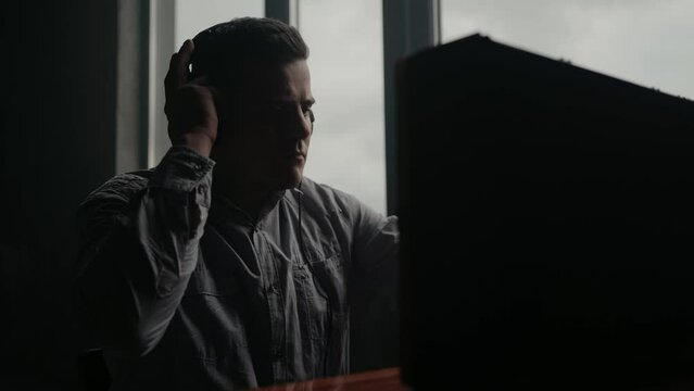 Secret agent listens on the reel tape recorder. Officer wiretapping in headphones. Spying of conversations. Intelligence gathering. Espionage concept. Report information to superiors.