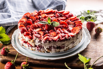 Strawberry cream cake with sponge cakes on a white plate