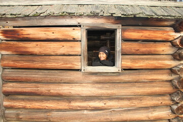 Woman poking her head on the log cabin window, Jockey Hollow, Morristown, New Jersey