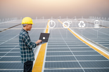 Asian Engineer use computer  Checking Solar power Energy in factory