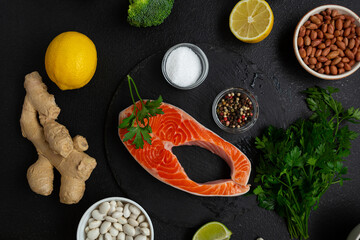  Top view of steak and vegetables on dark surface fish food cooking background