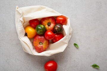 Top view Harvest homegrown heirloom tomatoes  organic food in cotton bag