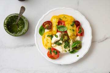 Heirloom, cherry tomatoes salad with burrata cheese top view