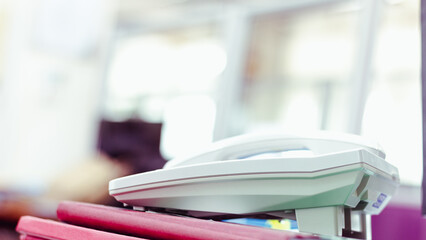 Office telephone on desk,telephone on table with blur office background..