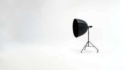 One studio lights of softbox and octobox stand against background of white cyclorama in photostudio