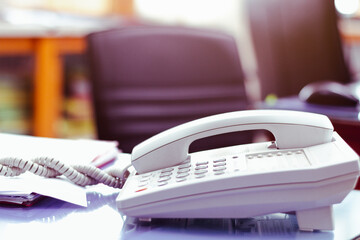 Office telephone on desk,telephone on table with blur office background..