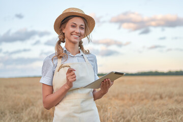 Woman farmer straw hat smart farming standing farmland smiling using digital tablet Female agronomist specialist research monitoring analysis data agribusiness