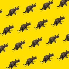 Toy Triceratops dinosaur pattern on a yellow background