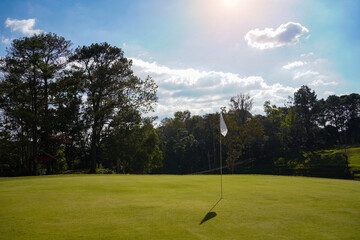 Obraz premium View of Golf Course with beautiful putting green. Golf course with a rich green turf beautiful scenery.