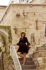 beautiful young woman in a hat smiling at camera in a luxury hotel in cappadocia	