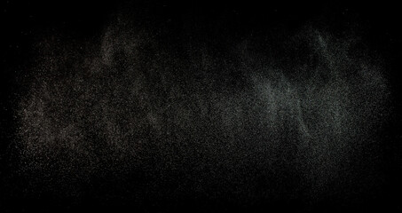 Sprayed water. Splashes and drops of water isolated on black background.