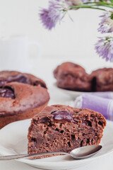 Piece of fresh chocolate cake close up on a festive table.