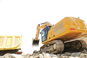Excavator on earthworks at construction site. Backhoe on foundation work and road construction. Heavy machinery and construction equipment. Excavator under building