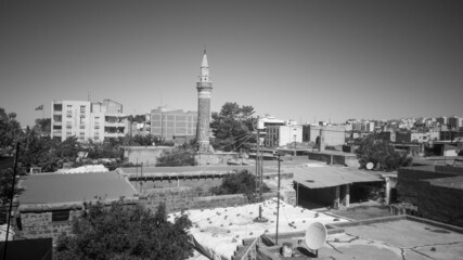 Black and white Muslim mosque in the middle of the city minaret