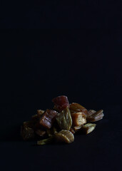 a pile of candied rheum isolated on black background. Image contains copy space