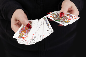 Female hands hold a deck of cards and show tricks.
The photographer is the author of the design of playing cards, which is written in the release of the property.