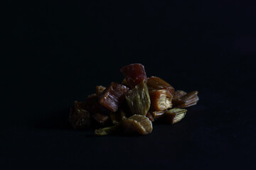 a pile of candied rheum isolated on black background. Image contains copy space