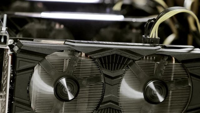 Close up details of modern mining rig with gpu, graphics cards used for creating bitcoin digital currency. Electronic devices with fans. Cryptocurrency miners.