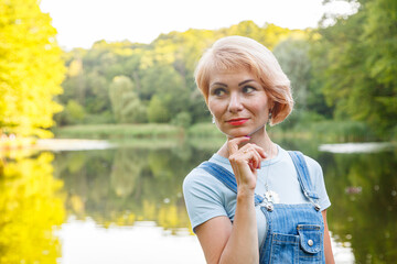 Fototapeta premium beautiful girl on the background on the shore against the backdrop of the lake