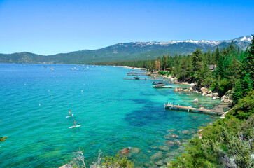 lake in the mountains, lake tahoe during summer, summer lake, summer activities on lake, stand up paddle boarding on lake, blue water
