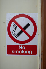 No smoking sign sticker on a cream white wall