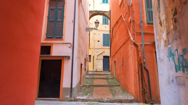 Narrow medieval street in Sanremo, Italy. Buildings made in classic style