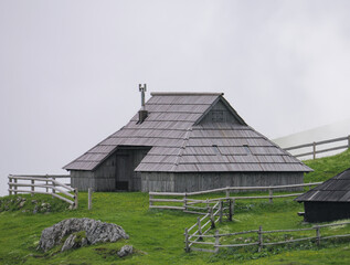 View of traditional Shepard cottage in the valley and the misty sky in the background, Velika...