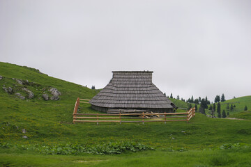 View of traditional Shepard cottage in the valley and the misty sky in the background, Velika...